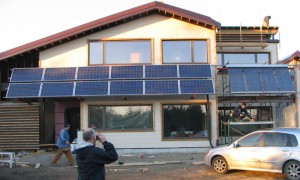 Solar PV panels and vacuum tube solar thermal collectors on strawbale house